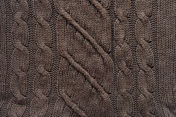 knitted texture background close up. Comfortable cloth warm wool sweater brown color. Abstract pattern textured woolen fabric background for autumn, winter time. flat lay