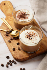 Italian chocolate and coffee mousse dessert semifreddo - half-frozen ice cream with whipped cream and cocoa powder in small glasses
