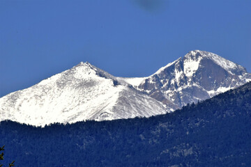 Beautiful view of a landscape with rocky mountains covered in sn