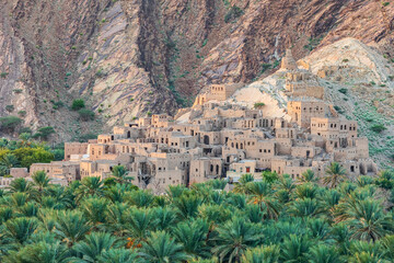 Middle East, Arabian Peninsula, Oman, Ad Dakhiliyah, Nizwa. Palm trees and a traditional mountain...