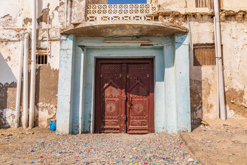 Middle East, Arabian Peninsula, Al Batinah South. Carved wooden door on a building in Oman.