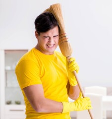 Man husband cleaning the house helping his wife