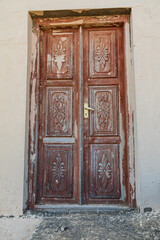 Middle East, Arabian Peninsula, Al Batinah South. Old carved wooden door on a building in Oman.