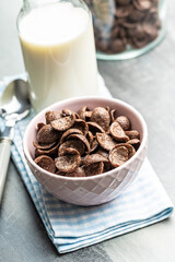 Sweet chocolate breakfast cereal flakes in bowl.