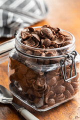 Sweet chocolate breakfast cereal flakes in jar.