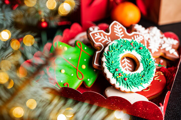 Christmas composition. A Christmas tree decorated with toys and a garland and gingerbreads.