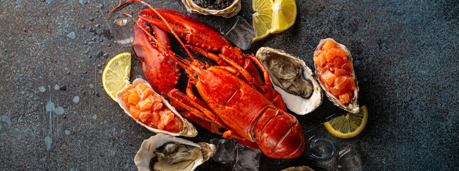 Seafood assorted plate with cooked red whole lobster, fresh open oysters, black caviar, salmon...