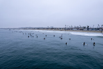 Aerial view of surfers riding the waves in Newport Beach, California