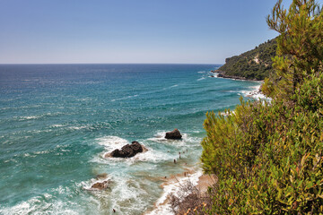Sea waves crashing onto rocks with water splashes. Corfu island, Greece.