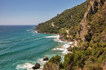 Fototapeta premium Sea waves crashing onto rocks with water splashes. Corfu island, Greece.