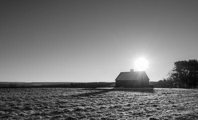 barn and sunrise over empty field