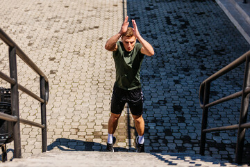 Young man athlete training on a stadium. Jumping upstairs on staircase and warming up before run....