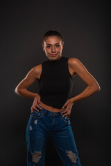 Smiling and posing with her hands on her hips