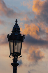 Hungary, Budapest. Light post against sunset clouds.