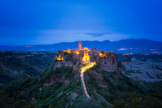 Europe, Italy, Civita di Bagnoregio. Medieval hilltop town lit at sunset. - Powered by Adobe