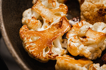 Roasted cauliflower with herbs and spices. Vegetarian food, healthy food baked in the oven. Selective focus