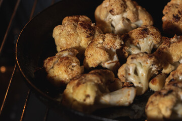 Roasted cauliflower with herbs and spices. Vegetarian food, healthy food baked in the oven. Selective focus