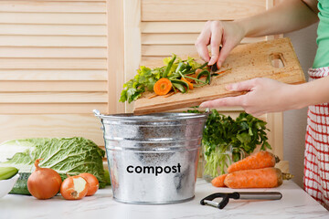 Wonan throws vegetable peeling, scraps in compost bucket. Food waste reduce. Sorting of household...