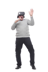 in full growth. smiling man in virtual reality glasses.