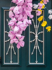 Portugal, Tomar. A close-up of the paper flowers hanging by a door that are used for decorations during the Festa dos Tabuleiros.
