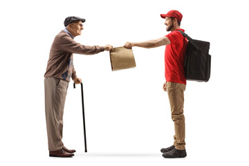 Full length profile shot of a guy delivering takeaway food bag to a pensioner