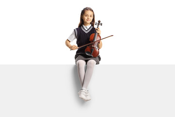 Schoolgirl sitting on a blank panel and holding a violin