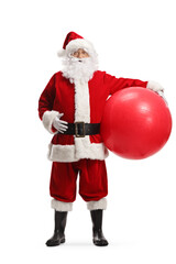 Full length portrait of santa claus holding a big fitness ball under his arm