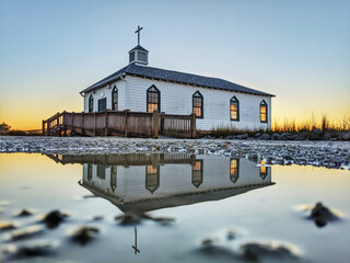 Beautiful scenery of Pawleys island chapel and its reflection with a sunset background