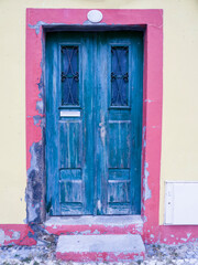 Portugal, Aveiro. Very old blue wooden door along the streets of Aveiro.