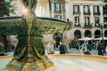 Beautiful historic fountain in Plaza Real in Barcelona, Spain. Famous square in Gothic quarter. Popular tourist attraction. - obrazy, fototapety, plakaty