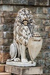 Siniai, Romania. Peles Castle. Statue of lion holding shield.