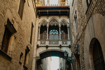 Ancient building - Pont del Bisbe Bishop Bridge alley in old part of Barcelona - Gothic Quarter. Popular travel destination.