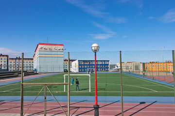 Colorfully painted buildings with track field, Anadyr, Chukotka Autonomous Okrug, Russia