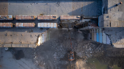 Excavator for dismantling buildings, using a special claw, dismantles a multi-storey building. View...