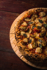 Delicious Pizza Classic Homemade Tomato Sauce Sausage Cheese Onion Chicken Meat Pasta Shrimp Restaurant Menu Gourmet on a wooden table Dark Background