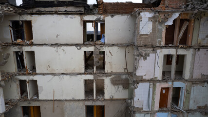Dilapidated building with abandoned colorful rooms and furniture. Consequences of natural disasters: earthquakes, tornadoes; explosion, war or terrorism.