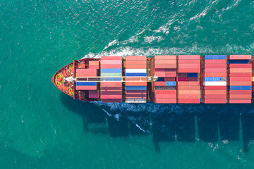 Aerial top view of cargo ship carrying container for import export goods  to customer,concept...