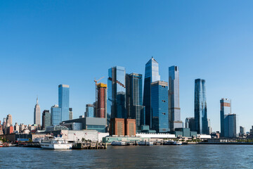 Naklejka premium New York City skyline from New Jersey over the Hudson River with the skyscrapers of the Hudson Yards district at day time. Manhattan, Midtown, NYC, USA. A vibrant business neighborhood