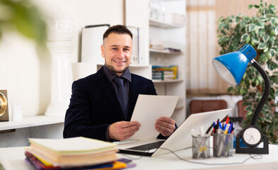 Professional business man using laptop at workplace in office