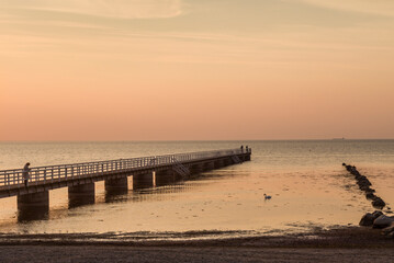 Fototapeta premium Sweden, Scania, Malmo, Riberborgs Stranden beach area, pier at sunset