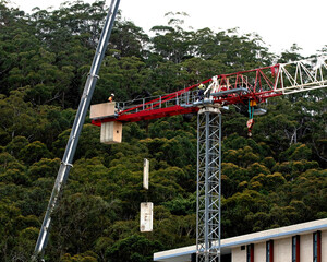 8:95 am December 7, 2021: Gosford, NSW, Australia. Tower Crane disassembly. Removing Counterweights.