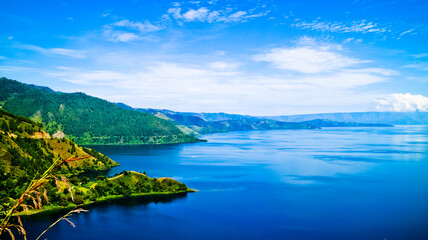 Naklejka premium The beauty of Lake Toba which is a caldera lake comes from an ancient volcanic eruption and is the largest volcanic lake in the world. North Sumatra, Indonesia