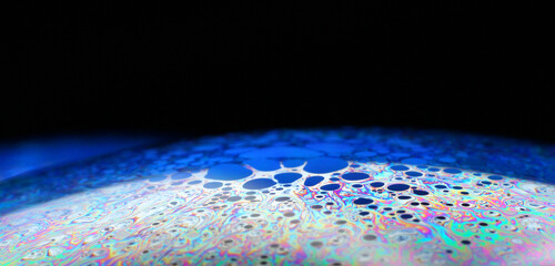 The bright colors seen in an oil slick floating on water or in a sunlit soap bubble are caused by interference