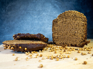 Sliced ​​brown bread sprinkled with coriander. Borodino bread. Flour product.