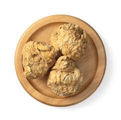 Dried yellow Maca in the wooden bowl, isolated on white background, top view