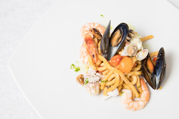 Passatelli with seafood, clams, mussels and shrimps. Typical Italian pasta most commonly cooked in...