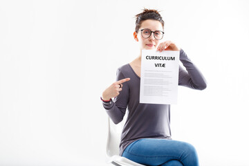 young woman sat showing her well done resume