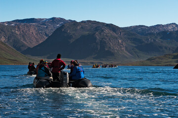 Tourists riding on zodiac in Arsuk Fjord, Greenland