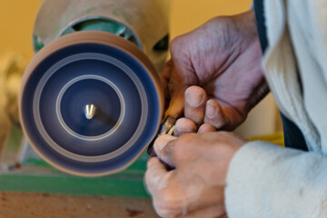 Artisan polishing muskox bone to make craft, Sisimiut, Greenland © Danita Delimont