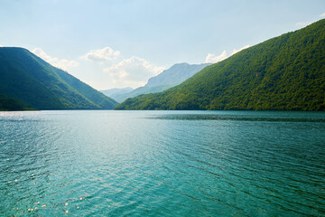 Calm turquoise lake between mountain peaks in Montenegro. Tranquil nature scene